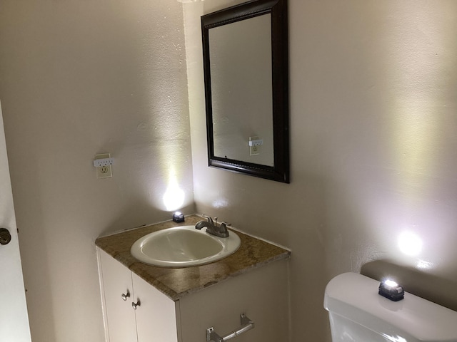 bathroom featuring toilet and vanity