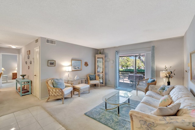 living area with light carpet, a textured ceiling, and visible vents