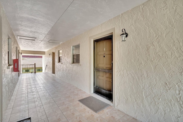 doorway to property featuring stucco siding