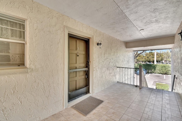 property entrance with stucco siding