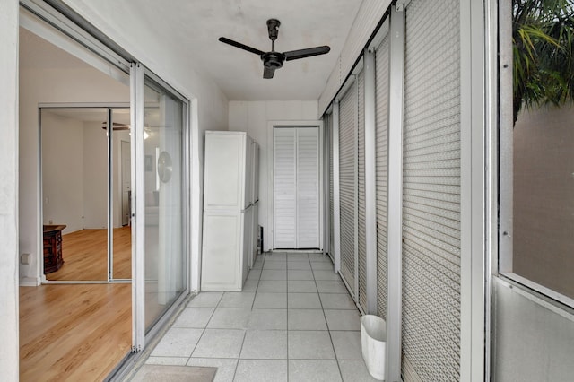 hall featuring light tile patterned flooring