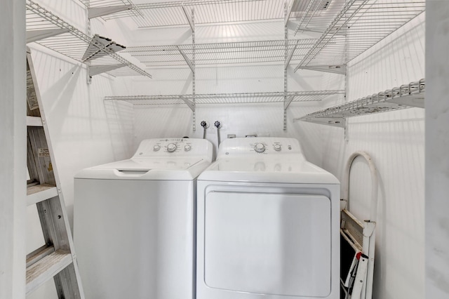 clothes washing area with washer and clothes dryer