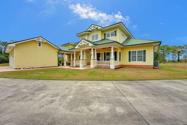 view of front of house featuring a porch, cooling unit, and a front lawn