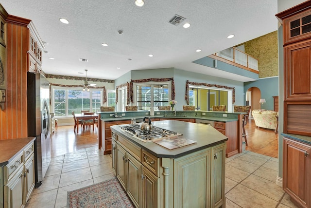 kitchen featuring dark countertops, a kitchen island, and visible vents