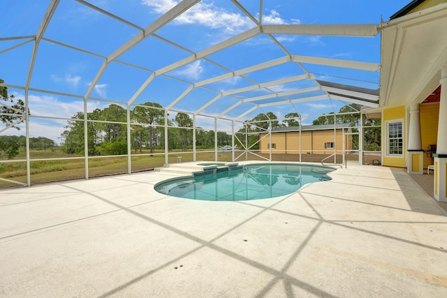 view of swimming pool with a lanai, a patio area, and a pool with connected hot tub