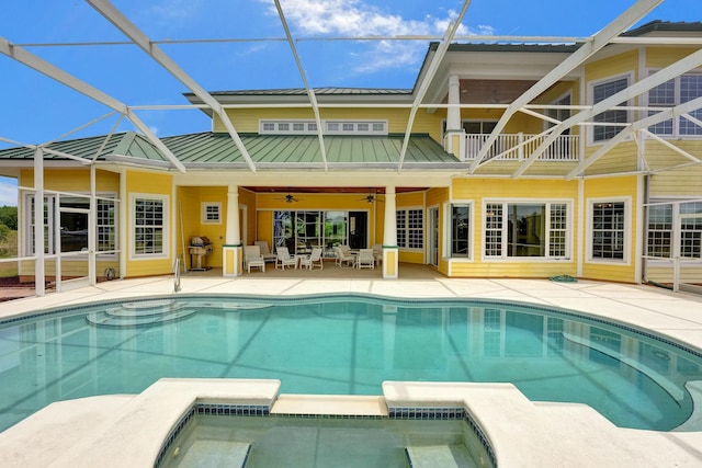 rear view of house featuring a patio, ceiling fan, metal roof, a lanai, and a standing seam roof