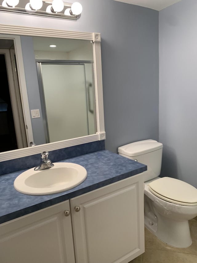 750 Burgundy P, Delray Beach, FL 33484 - full bathroom with vanity, a stall shower, toilet, and tile patterned floors