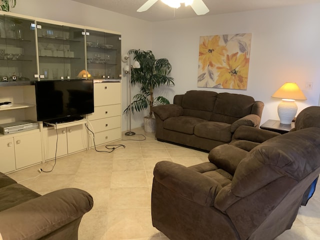 living room featuring light tile patterned floors and a ceiling fan