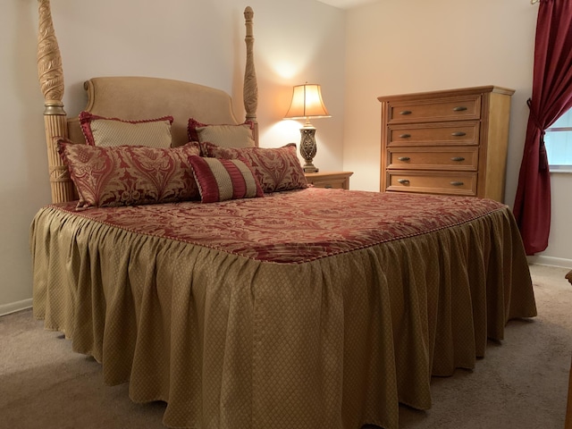 bedroom featuring light carpet and baseboards