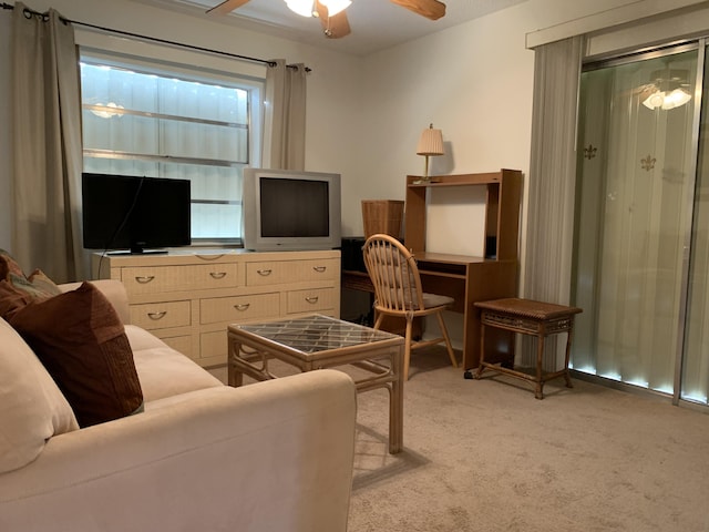 office space featuring a ceiling fan and light colored carpet