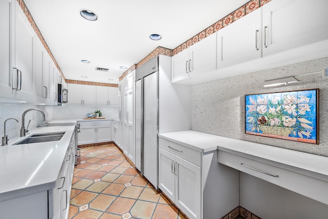 kitchen with stainless steel appliances, tasteful backsplash, and white cabinetry