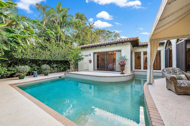 view of swimming pool with a fenced in pool and a patio area