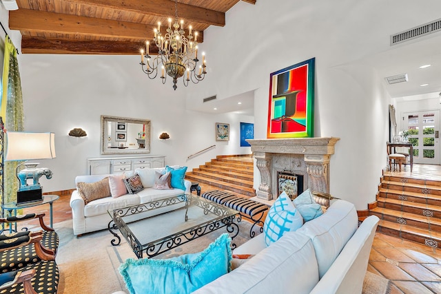 living area with wooden ceiling, a premium fireplace, visible vents, stairway, and beamed ceiling