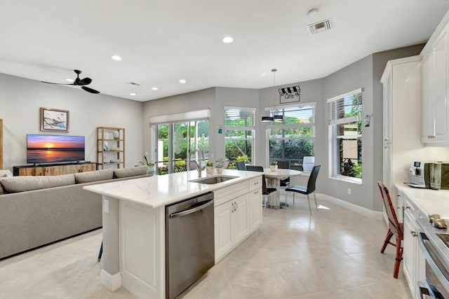 kitchen with dishwasher, open floor plan, a sink, and recessed lighting