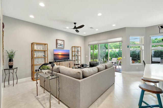 living room featuring baseboards, light tile patterned floors, visible vents, and recessed lighting