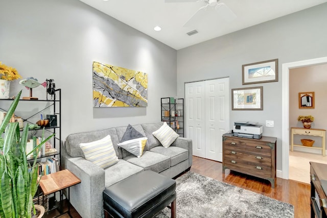 living room with a ceiling fan, recessed lighting, visible vents, and wood finished floors