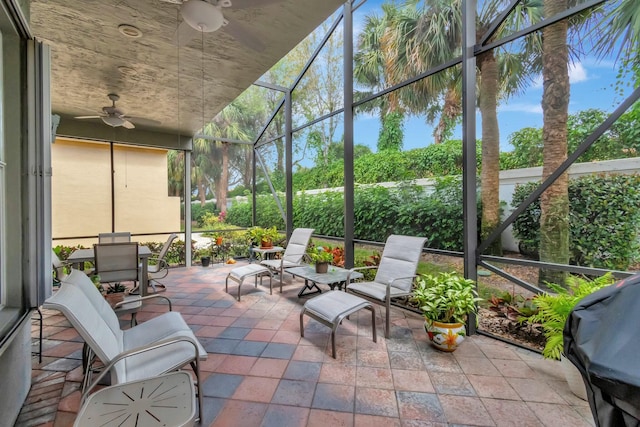 sunroom with a ceiling fan