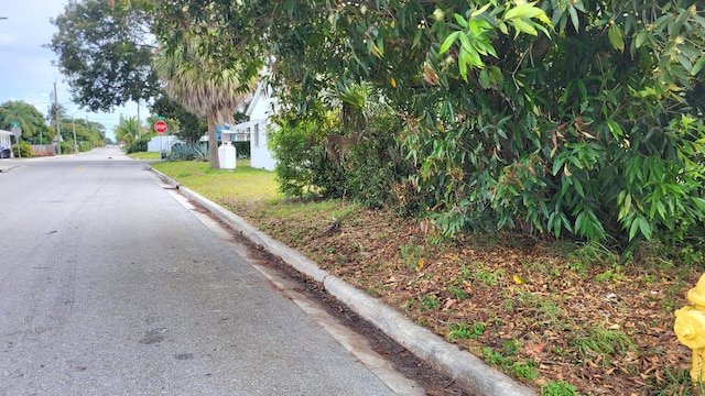 view of road with curbs and traffic signs