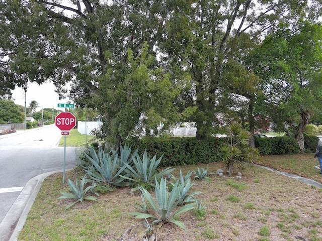 exterior space featuring curbs and traffic signs