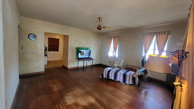 living area with baseboards and wood finished floors