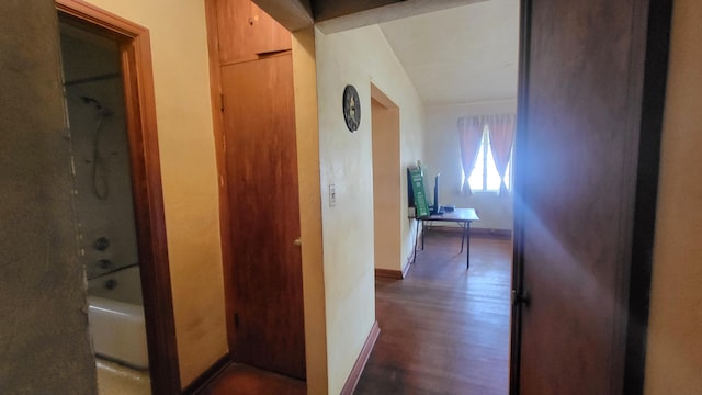 hallway with dark wood finished floors and baseboards