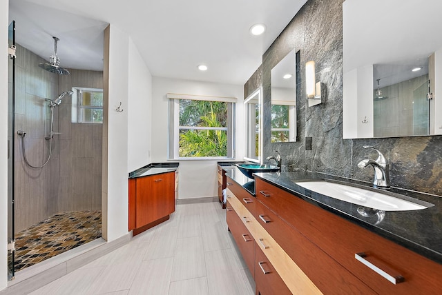 bathroom featuring a stall shower, baseboards, decorative backsplash, vanity, and recessed lighting