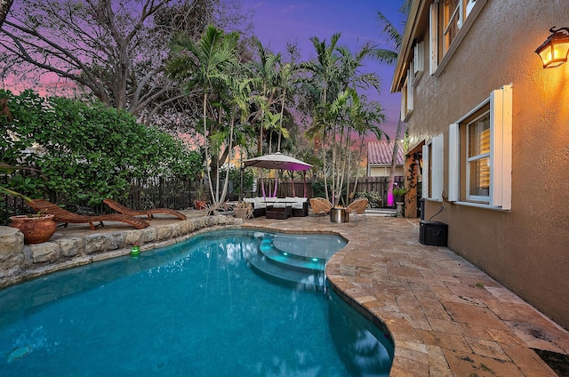 view of swimming pool with a patio area, a fenced backyard, and an outdoor living space