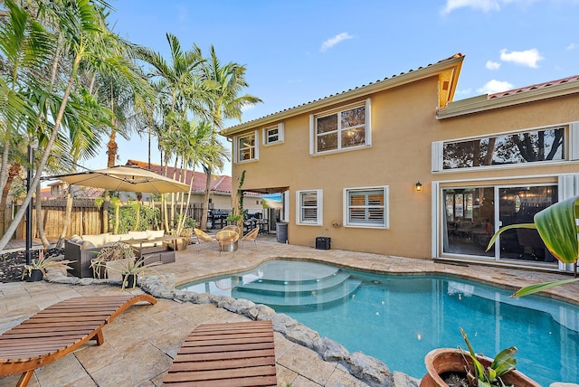 view of swimming pool featuring fence, an outdoor living space, a fenced in pool, and a patio