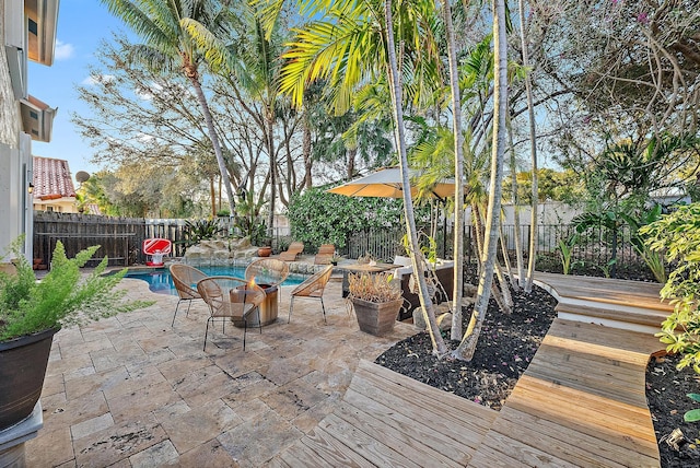 view of patio / terrace with a fenced backyard, a deck, and a fenced in pool