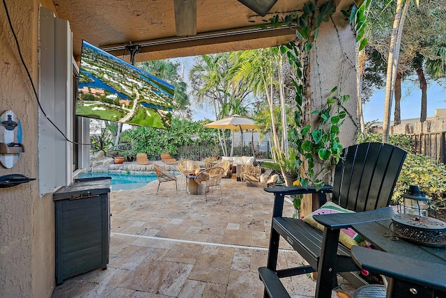 view of patio featuring an outdoor fire pit, a fenced backyard, and a fenced in pool