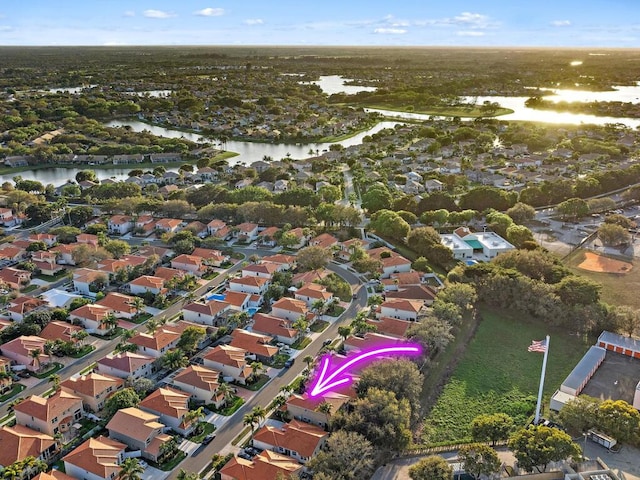 birds eye view of property featuring a water view and a residential view