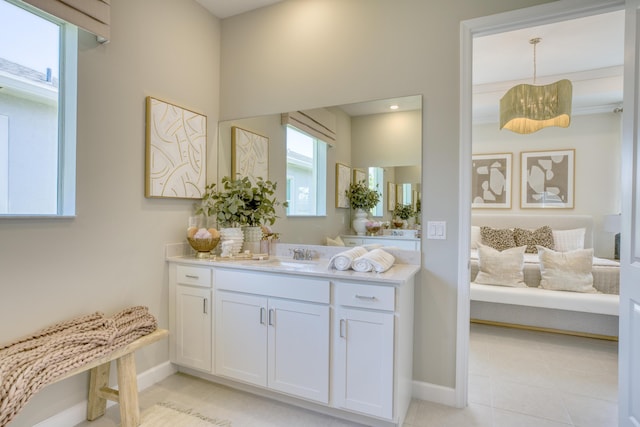 full bath with baseboards, vanity, and tile patterned floors