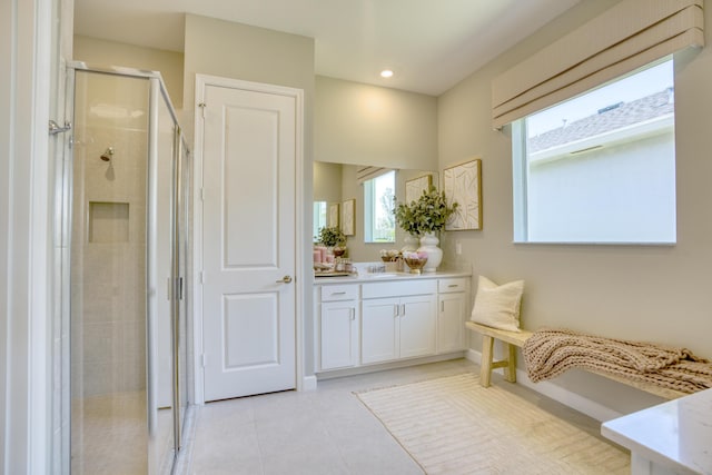 full bathroom featuring a stall shower, vanity, a wealth of natural light, and tile patterned floors