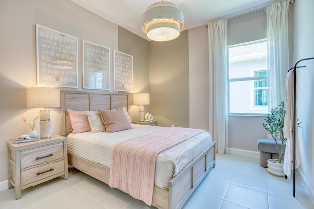 bedroom featuring light tile patterned floors and baseboards