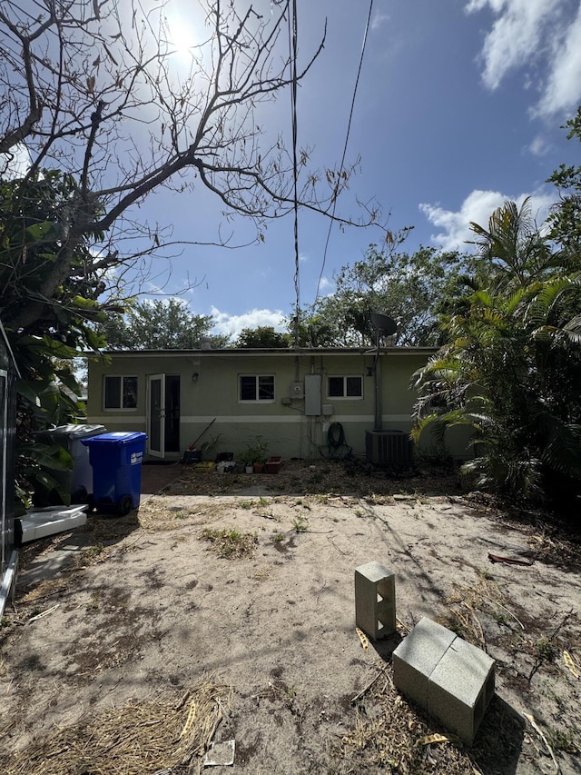 rear view of property featuring cooling unit and french doors