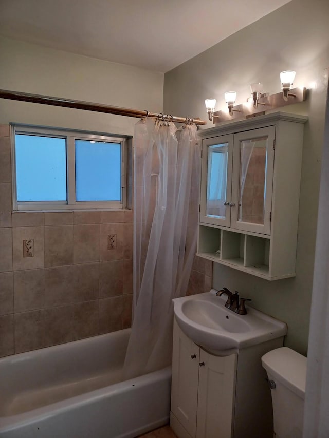 full bathroom with vanity, shower / bath combination with curtain, and toilet