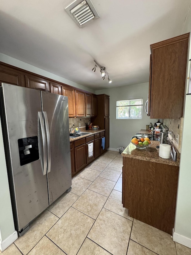 kitchen featuring stainless steel fridge with ice dispenser, visible vents, backsplash, and light tile patterned floors