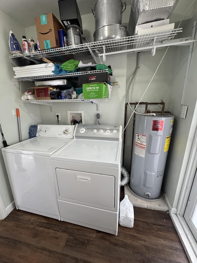 washroom with water heater, washer and clothes dryer, dark wood-style floors, laundry area, and baseboards