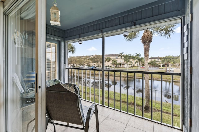 balcony featuring a water view and a residential view