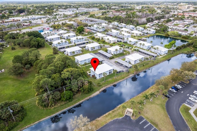 birds eye view of property with a water view and a residential view