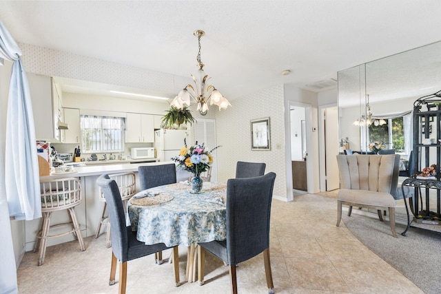 dining area featuring a notable chandelier, light tile patterned floors, baseboards, and wallpapered walls