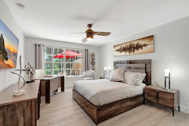 kitchen with tasteful backsplash, light stone countertops, stainless steel appliances, white cabinetry, and a sink