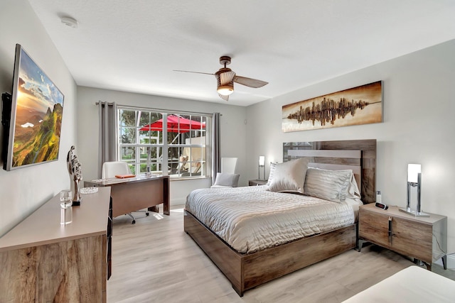 bedroom with light wood finished floors and ceiling fan