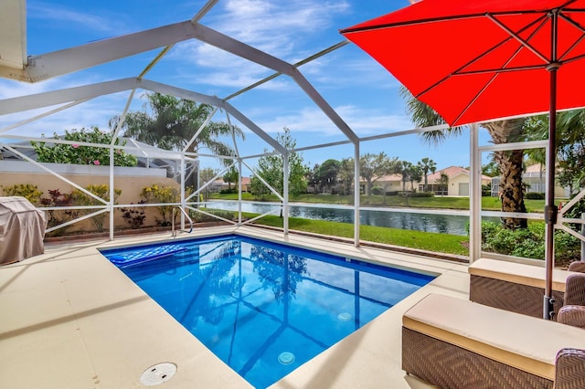 outdoor pool with a patio area, a water view, a grill, and a lanai