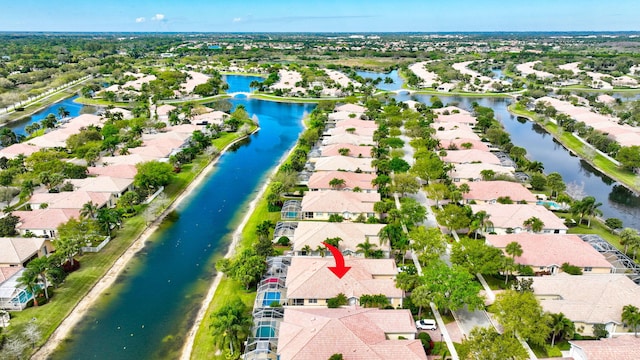 birds eye view of property with a water view and a residential view