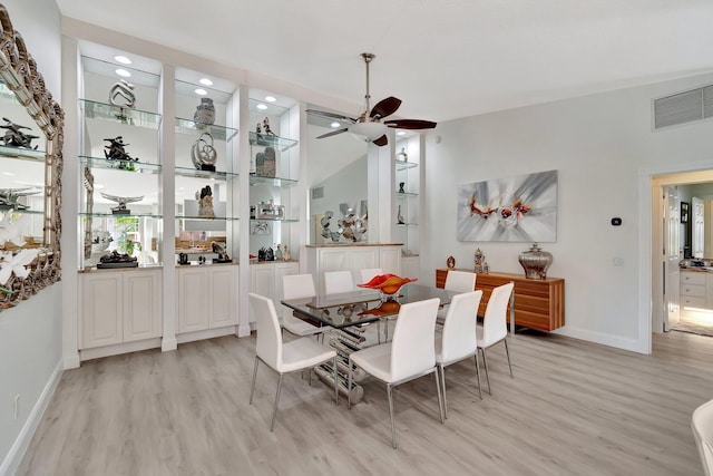 dining room with a ceiling fan, light wood-type flooring, visible vents, and baseboards