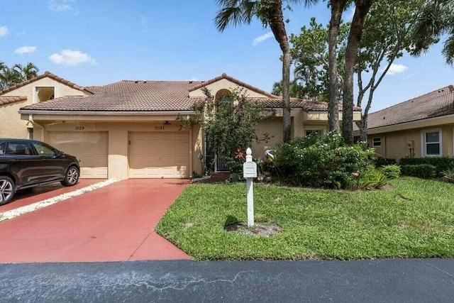 view of front of property with a garage, a tile roof, driveway, stucco siding, and a front lawn