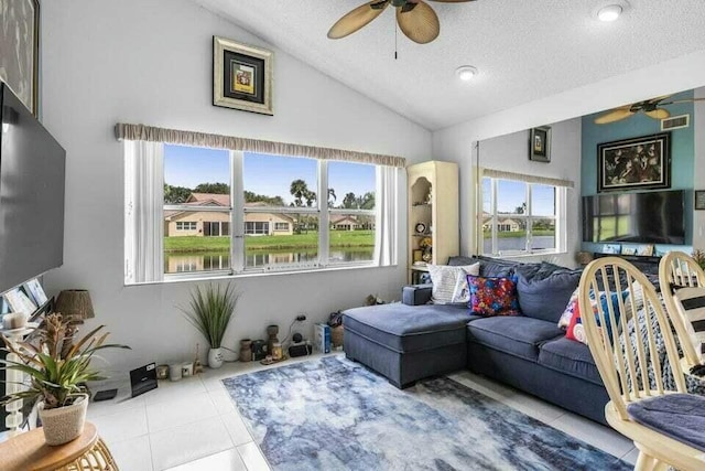 tiled living area with lofted ceiling, visible vents, a textured ceiling, and a ceiling fan