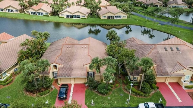 drone / aerial view featuring a water view and a residential view