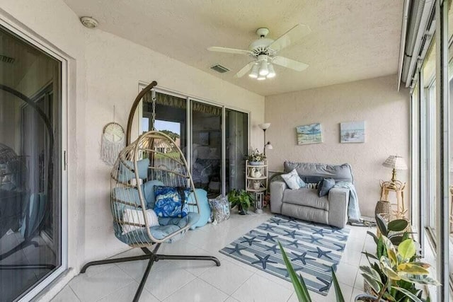 sunroom with visible vents and a ceiling fan